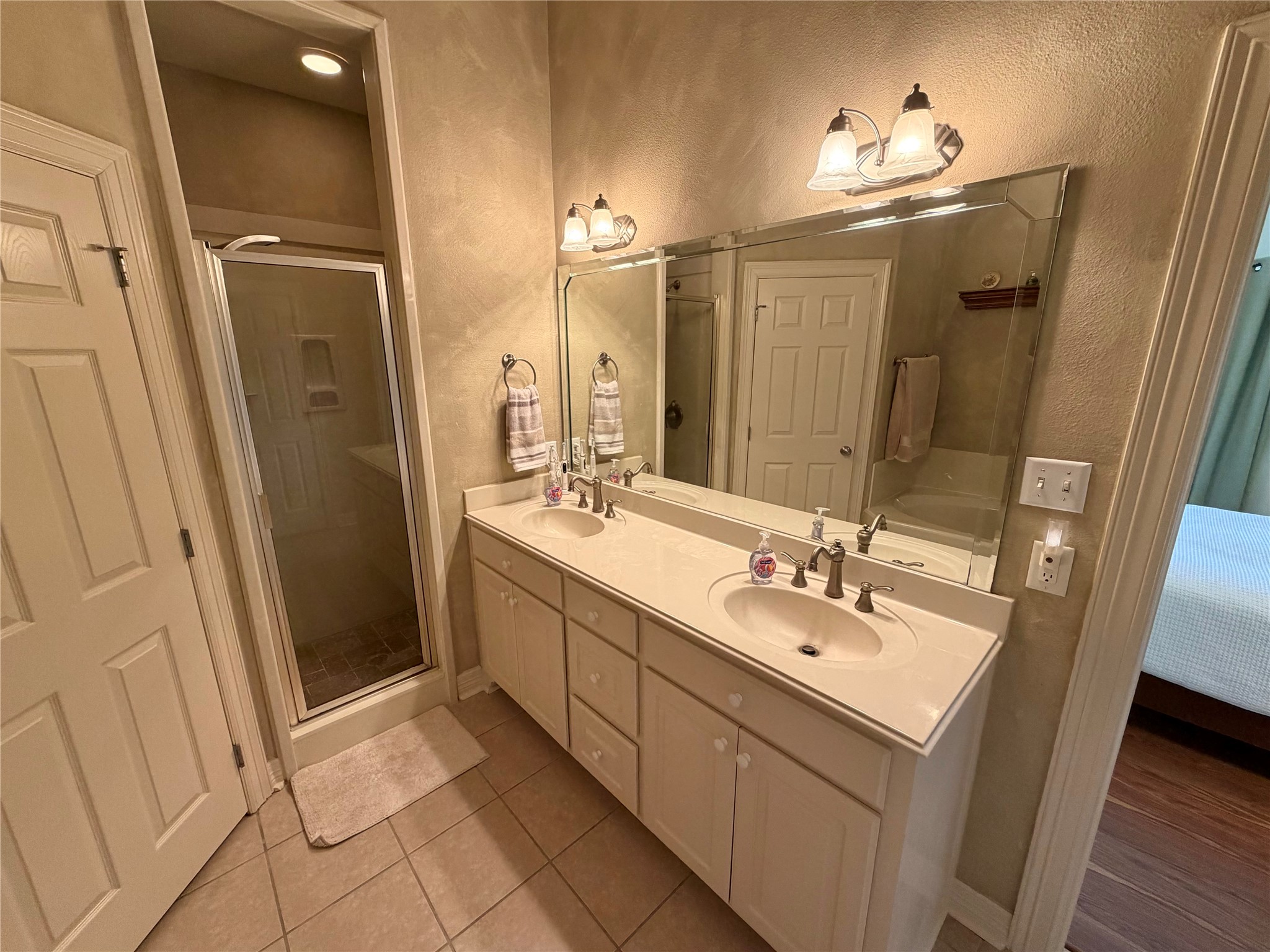 1448 South Blue Bonnet Lane Angleton, TX 77515 - Photo 28 of 43 a bathroom with a double vanity sink and mirror