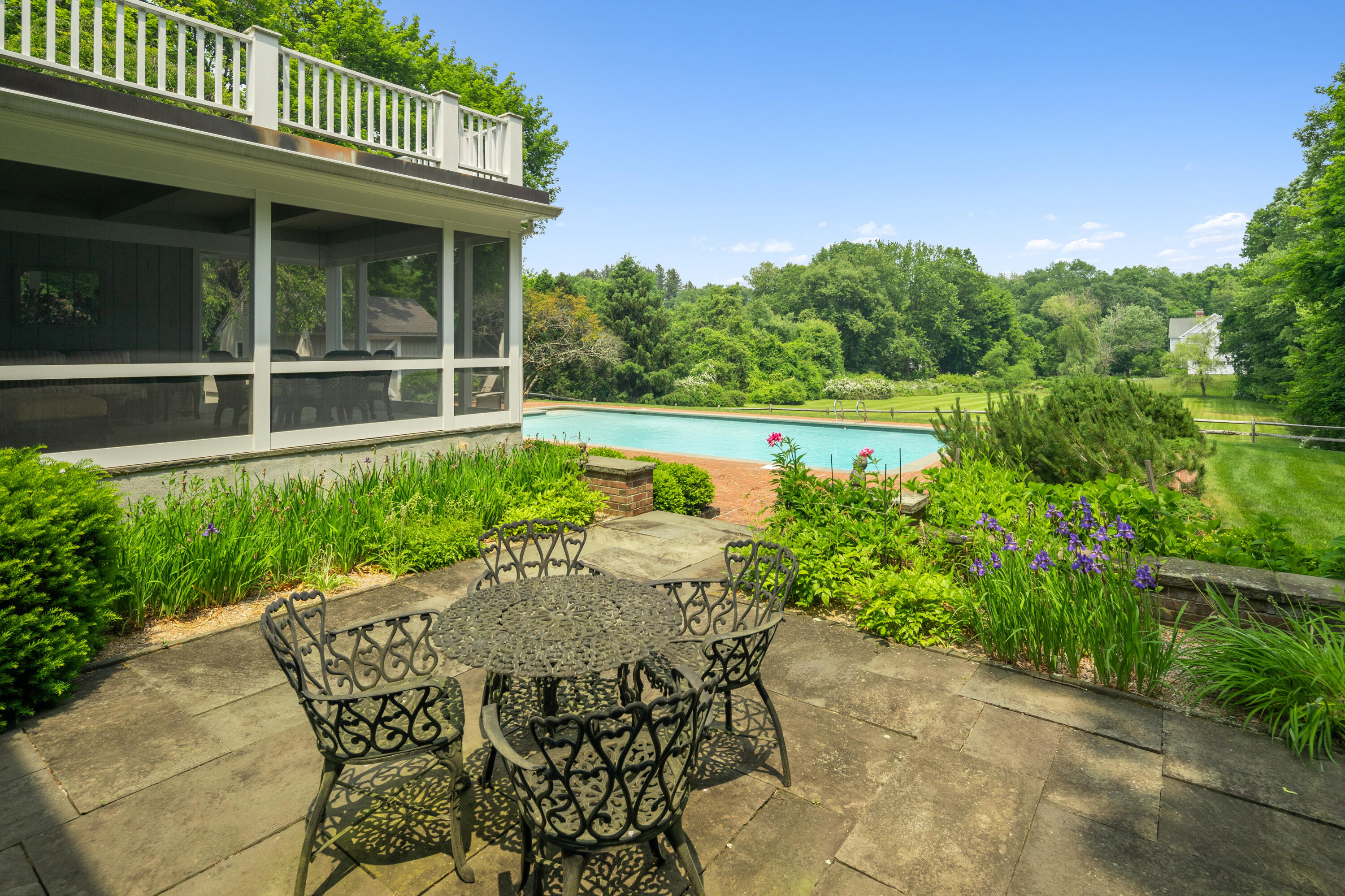 246 White Oak Shade Road New Canaan, CT 06840 - Photo 37 of 38 a view of a chair and table in the patio with a garden