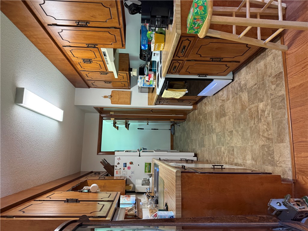 407 Seawright Drive Pendleton, SC 29670 - Photo 26 of 29 Rich wood cabinetry paired with resilient vinyl flooring defines this functional galley kitchen layout.