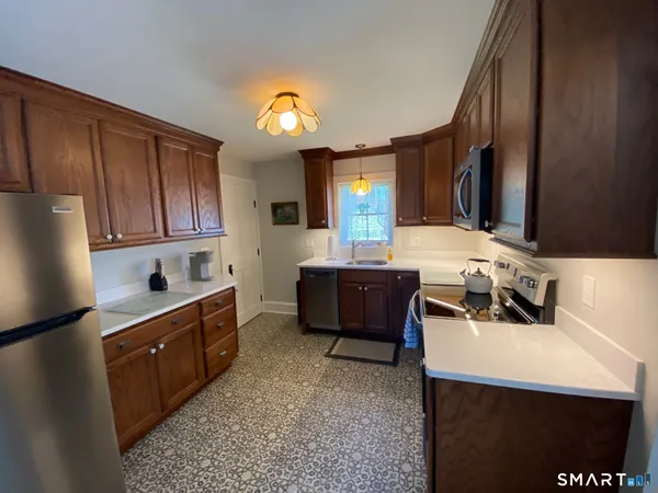 a kitchen with a sink and a stove top oven