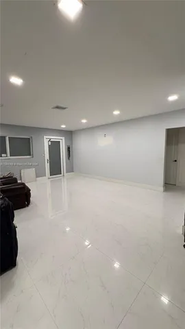 a view of a livingroom with furniture and car