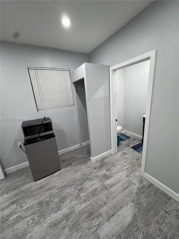 a living room with a stove and a refrigerator