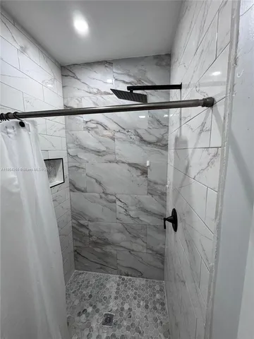 an empty room with wooden floor and cabinet