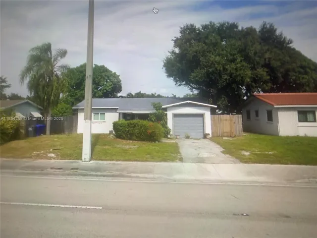 a house that has a tree in front of it