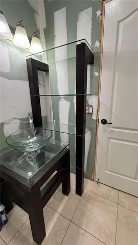 a bathroom with a sink mirror and toilet