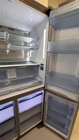 a kitchen with granite countertop white cabinets and a stove