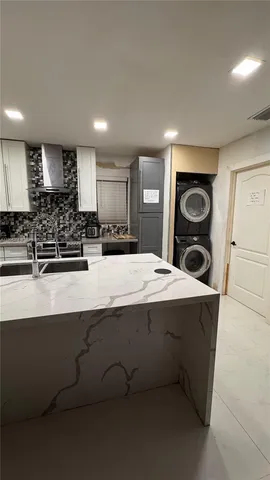 a kitchen with kitchen island sink and stove