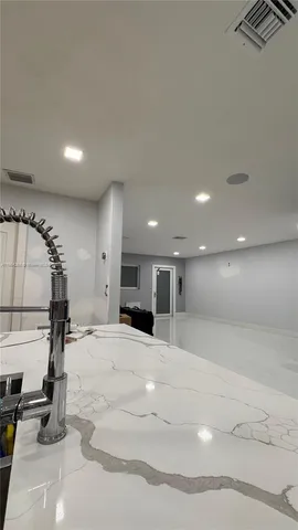 a view of a kitchen with a sink and microwave