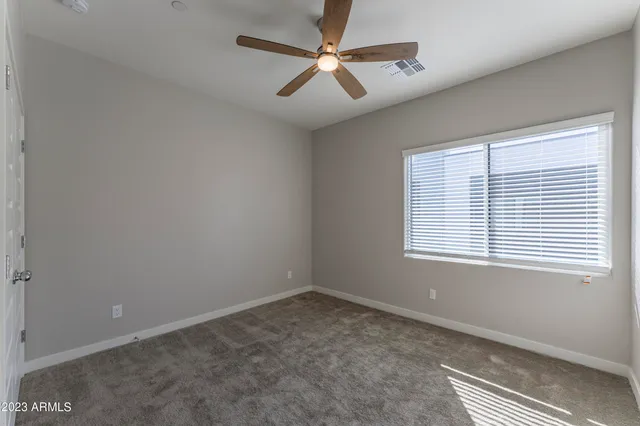 a view of a balcony with two couches and potted plants