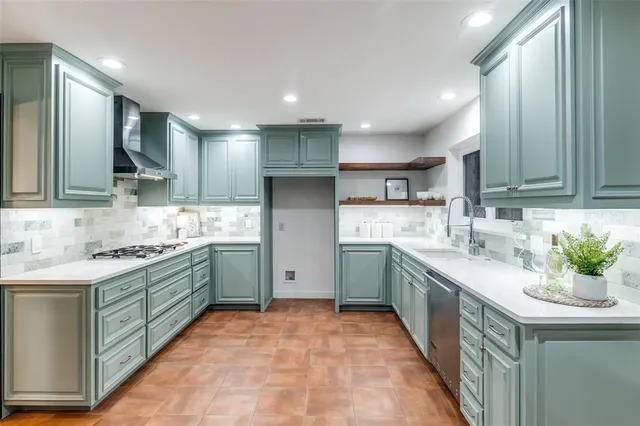 a kitchen with a sink stove and cabinets