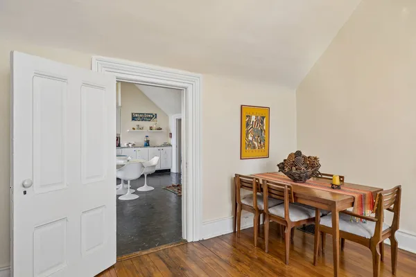 a bedroom with a bed and a flat tv screen on dresser