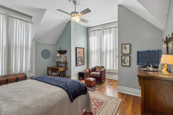 a bedroom with a bed and a television
