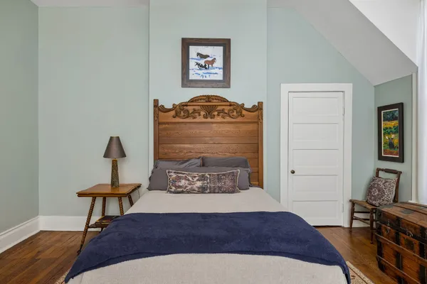 a view of a livingroom with furniture hardwood floor and closet