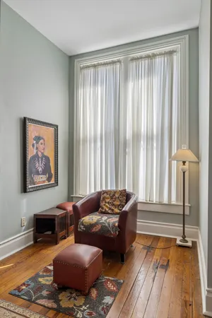 a living room with furniture and a book shelf