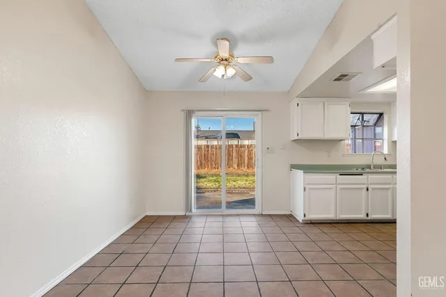 a kitchen with granite countertop a stove a sink and a refrigerator