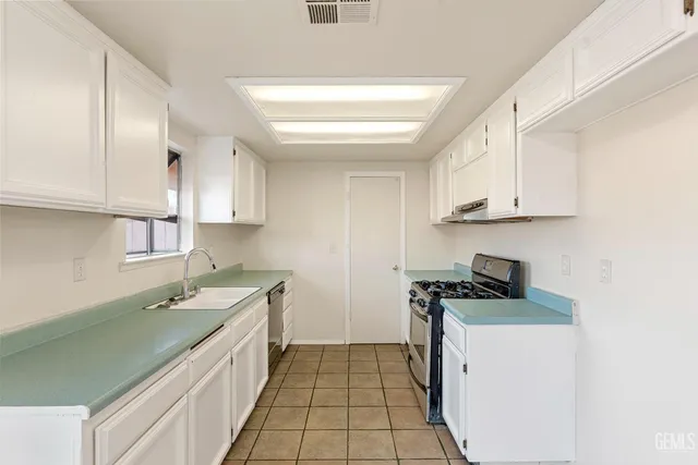 a kitchen that has a sink and a stove