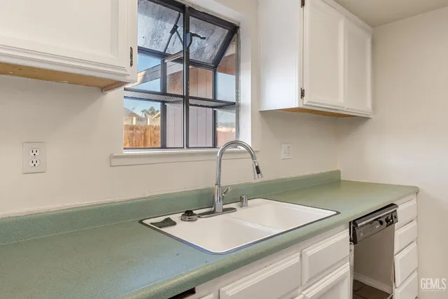 a kitchen with a sink and cabinets