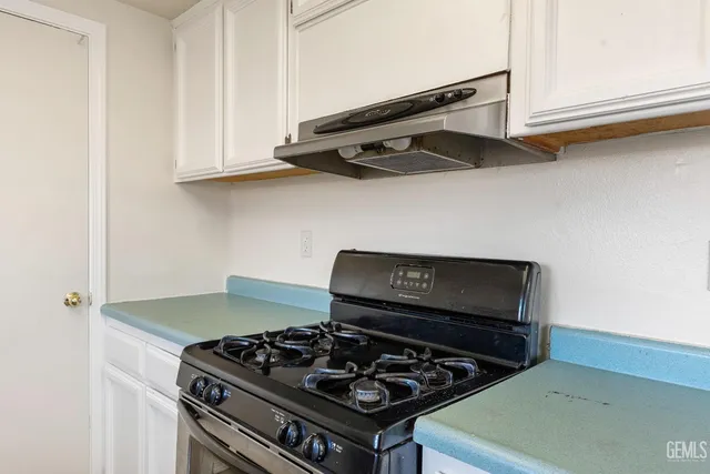 a stove top oven sitting inside of a kitchen