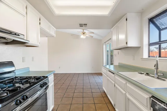 a kitchen with a sink stove and cabinets