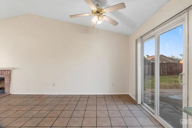 a view of an empty room and window chandelier fan