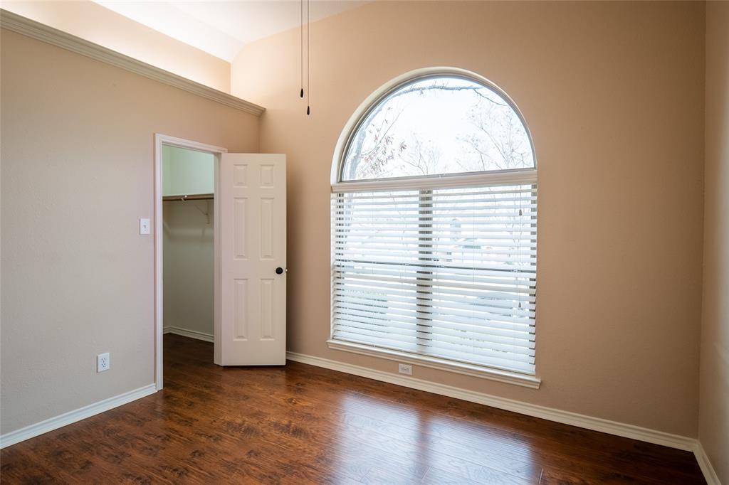 4664 Cherokee Path Carrollton, TX 75010 - Photo 15 of 21 an empty room with wooden floor closet and window