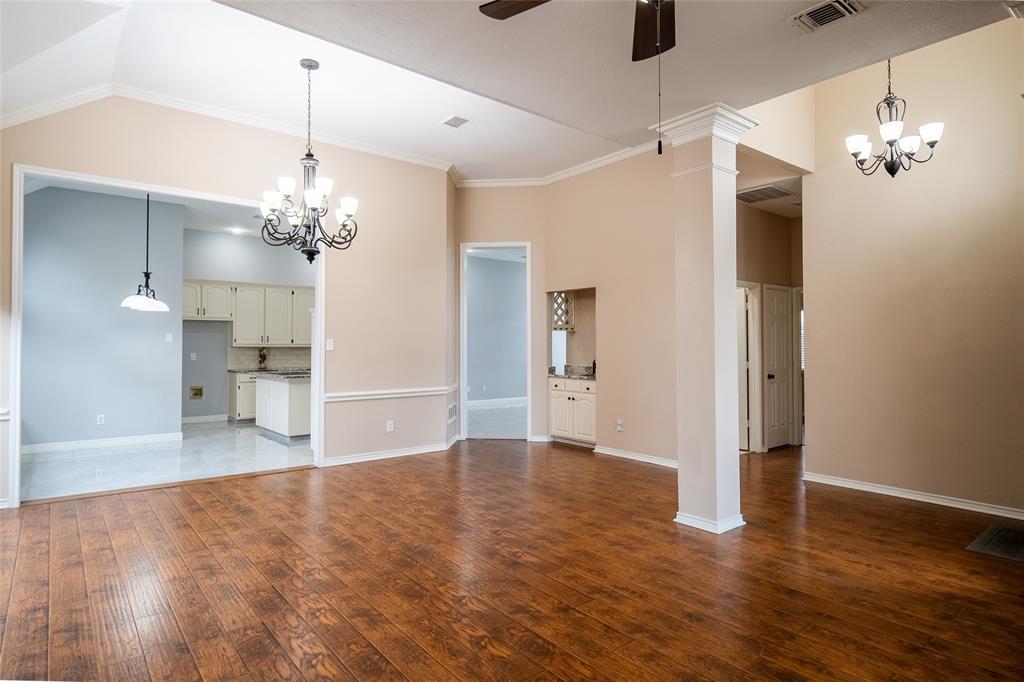 4664 Cherokee Path Carrollton, TX 75010 - Photo 21 of 21 a view of a livingroom with a chandelier fan and windows