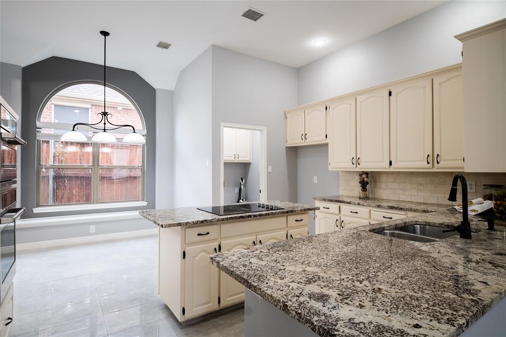 4664 Cherokee Path Carrollton, TX 75010 - Photo 5 of 21 a kitchen with stainless steel appliances granite countertop a stove a sink and a granite counter tops