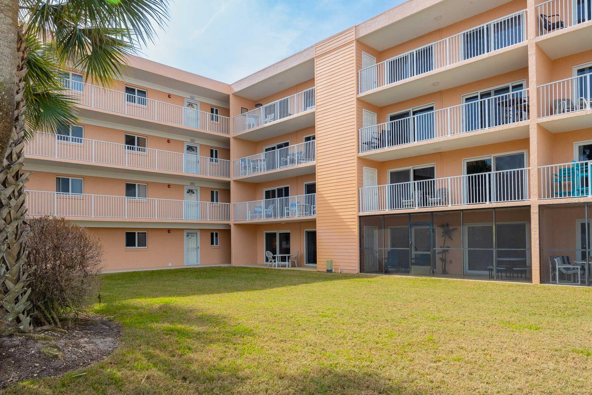 4 Ocean Trace Road, Unit 122 St. Augustine, FL 32080 - Photo 31 of 47 a front view of building with outdoor space and swimming pool