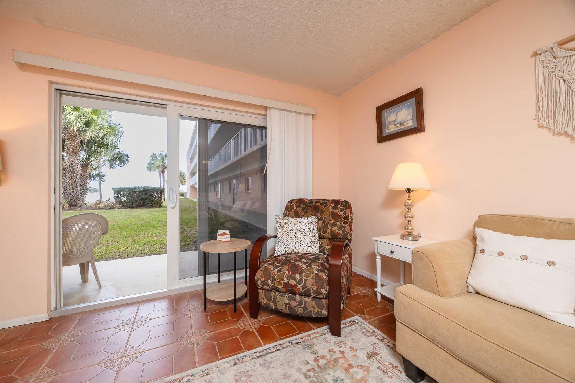 4 Ocean Trace Road, Unit 122 St. Augustine, FL 32080 - Photo 33 of 47 a living room with furniture and a large window