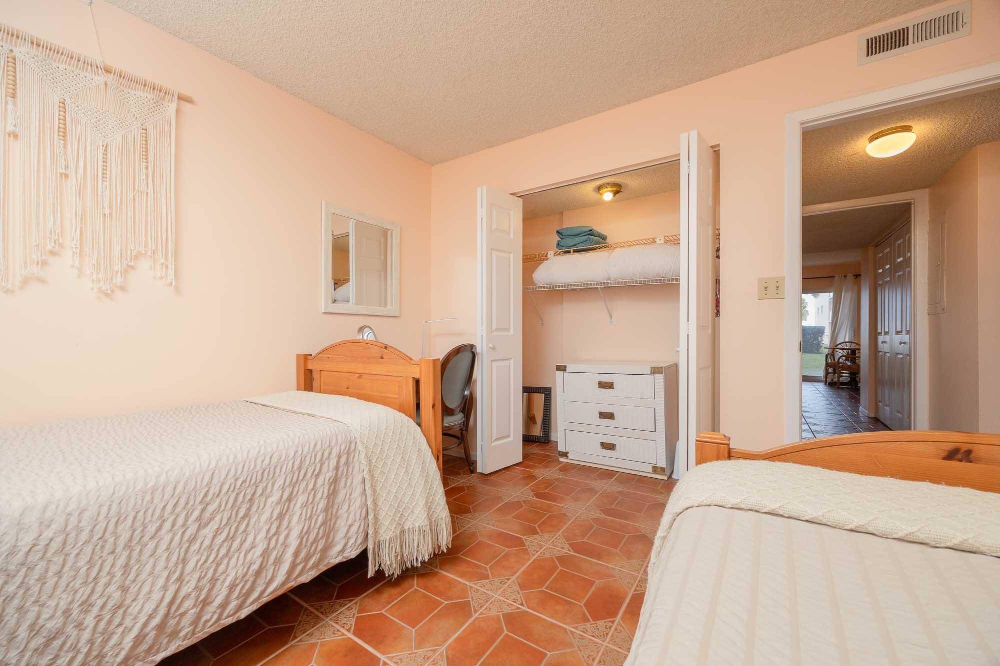 4 Ocean Trace Road, Unit 122 St. Augustine, FL 32080 - Photo 43 of 47 a bedroom with a bed and a mirror