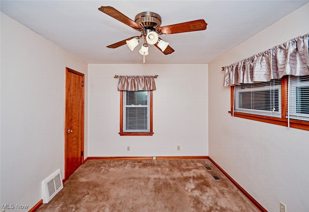 4858 Arbor Road Southwest Canton, OH 44710 - Photo 21 of 31 Carpeted spare room with ceiling fan