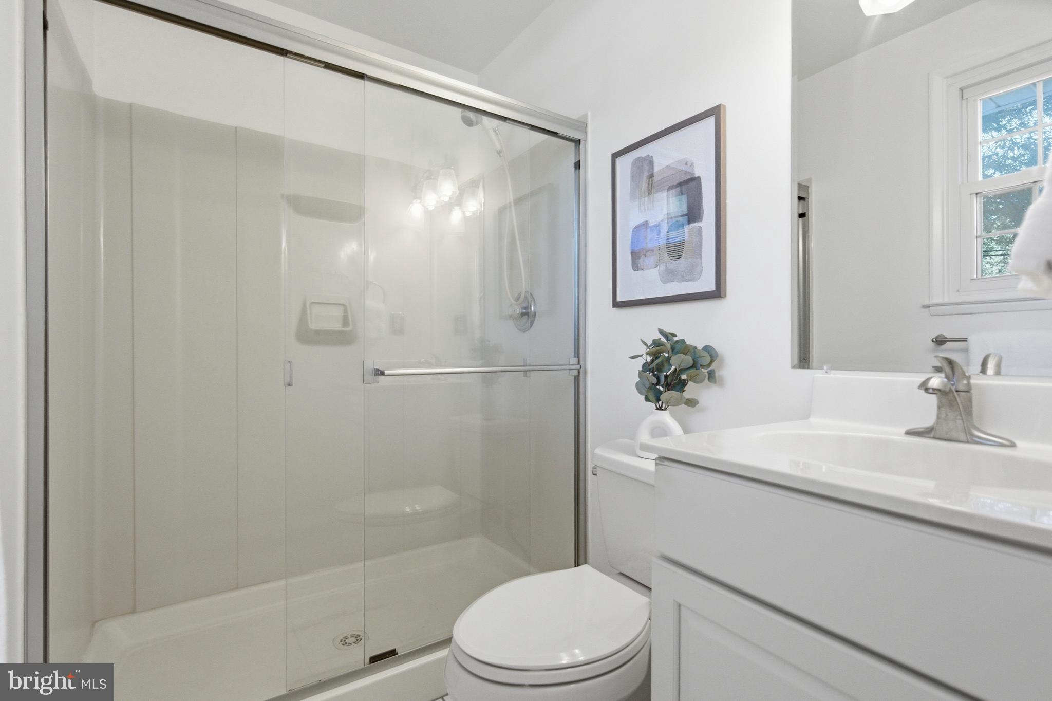 220 Solway Road Lutherville-Timonium, MD 21093 - Photo 15 of 38 a bathroom with a sink a toilet a shower and a mirror