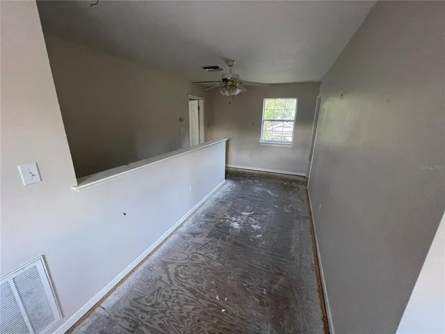 an empty room with windows and closet