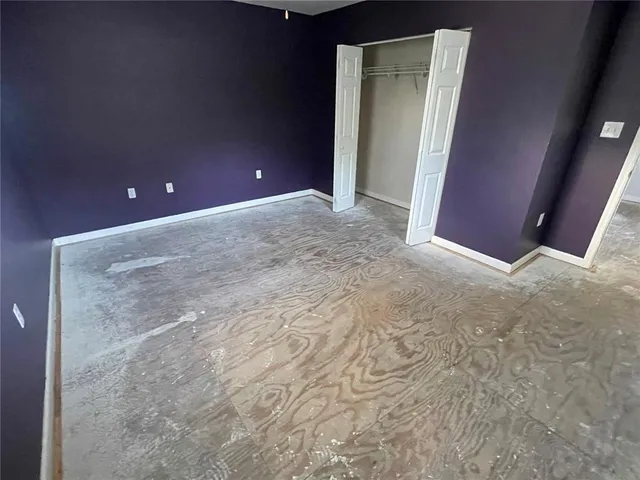 a view of a room with wooden floor