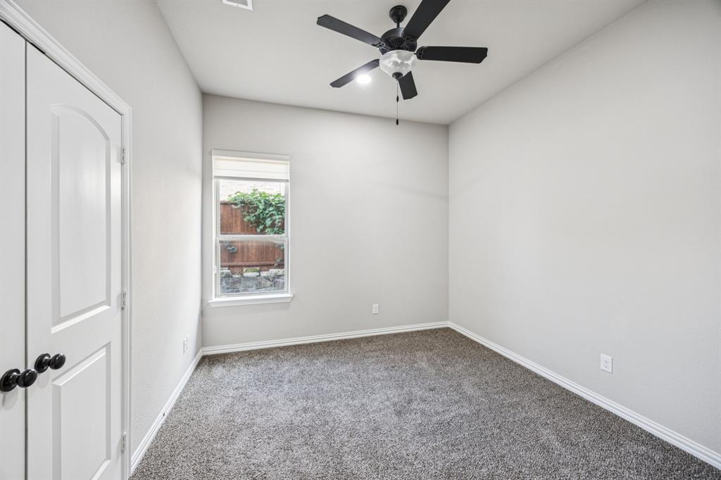 7205 Joshua Tree Trail McKinney, TX 75070 - Photo 11 of 32 an empty room with a window and a fan