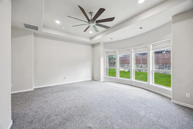 an empty room with closet and windows