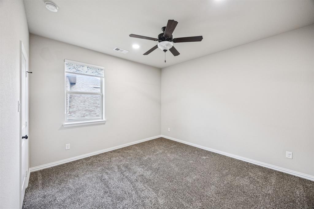 7205 Joshua Tree Trail McKinney, TX 75070 - Photo 25 of 32 an empty room with a window and a fan