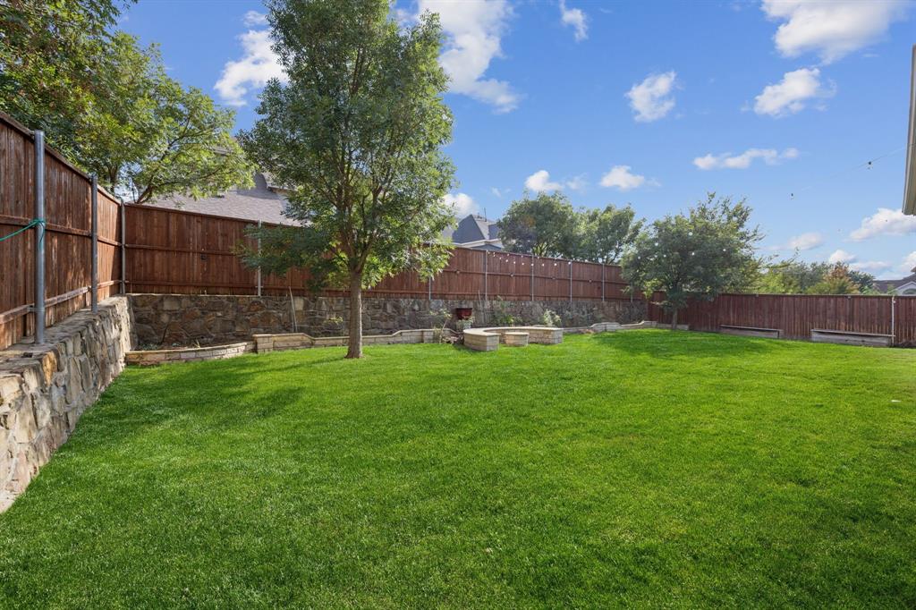 7205 Joshua Tree Trail McKinney, TX 75070 - Photo 30 of 32 a view of yard with green space and wooden fence