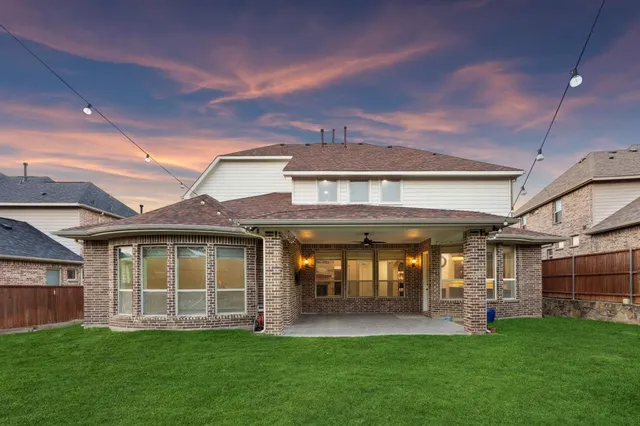 a view of yard with green space and wooden fence