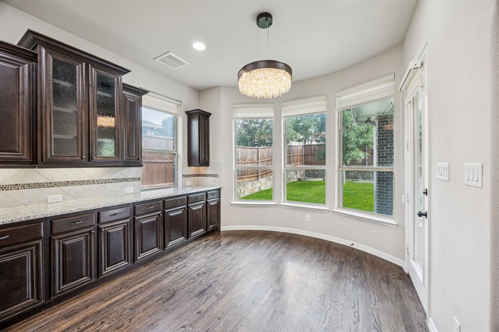 7205 Joshua Tree Trail McKinney, TX 75070 - Photo 6 of 32 a large kitchen with stainless steel appliances granite countertop a large cabinets a stove and a large window