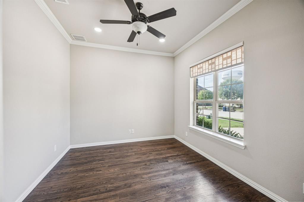 7205 Joshua Tree Trail McKinney, TX 75070 - Photo 9 of 32 a view of an empty room with wooden floor and a window