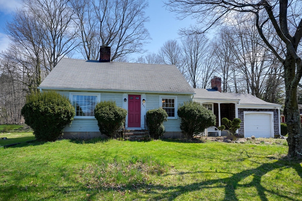 a front view of house with yard and green space