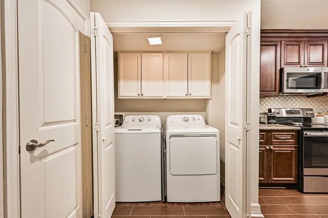a view of washer and dryer with wooden floor