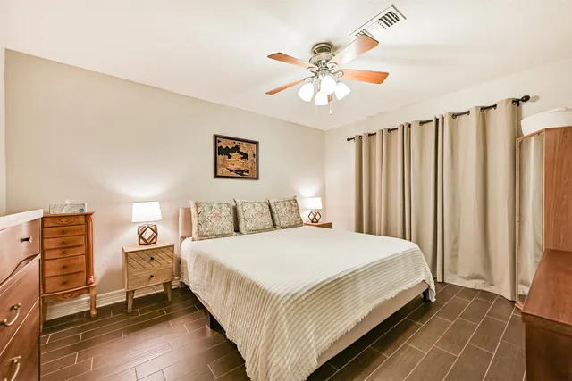 a bedroom with a bed and a chandelier