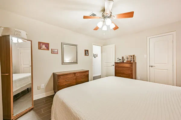 a bedroom with a large bed and a chandelier