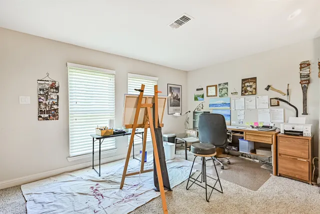 a work room with furniture and a window