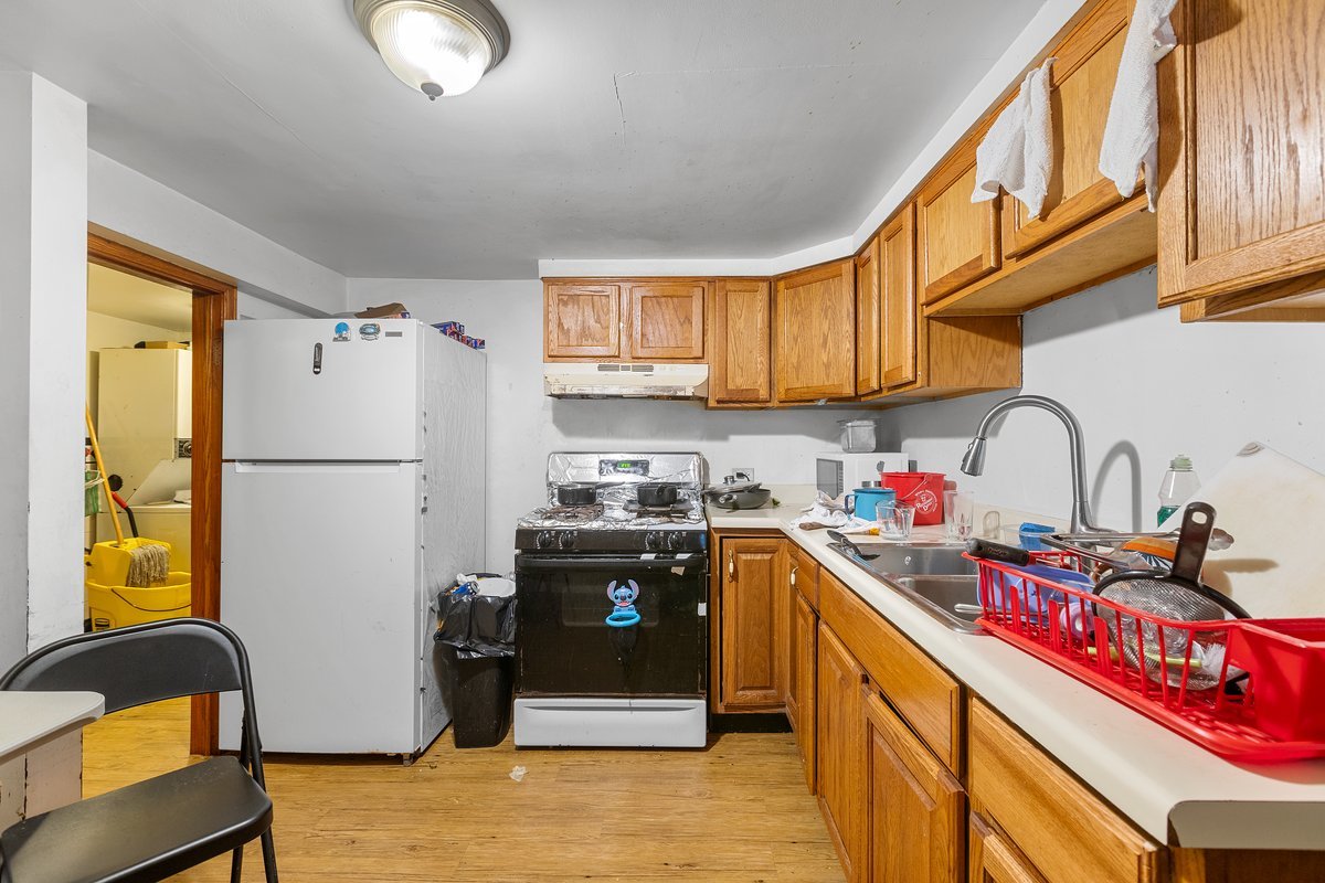 2708 West Division Street Chicago, IL 60622 - Photo 12 of 15 a kitchen with stainless steel appliances granite countertop a refrigerator sink stove and a granite counter top