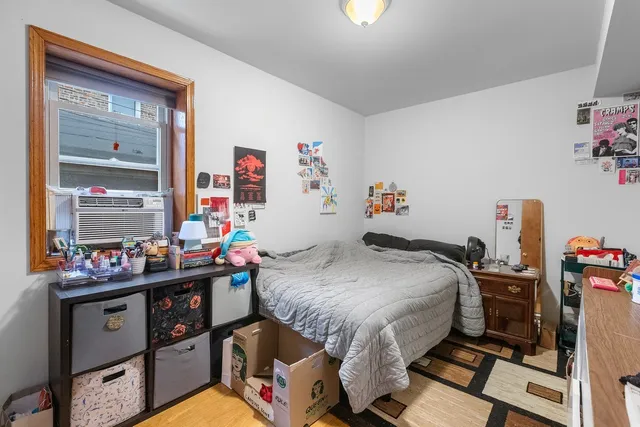 a bedroom with bed and a wooden floor