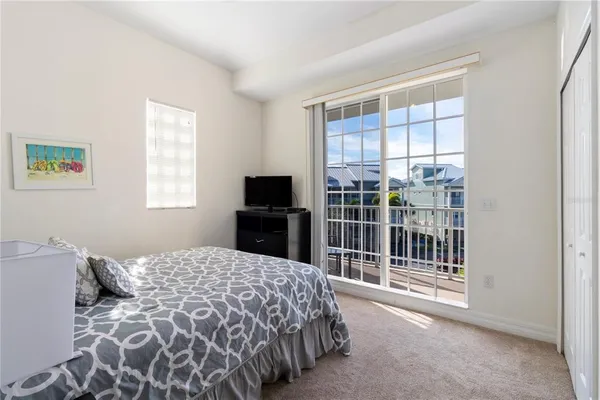 a bedroom with two beds and a chandelier