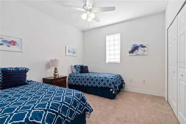 a bathroom with a granite countertop sink a toilet a mirror and shower